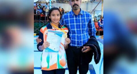 Students posing with teachers during a school celebration or achievement moment