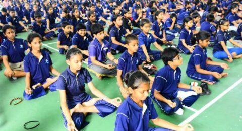 Students seated on ground participating in a group learning or awareness session